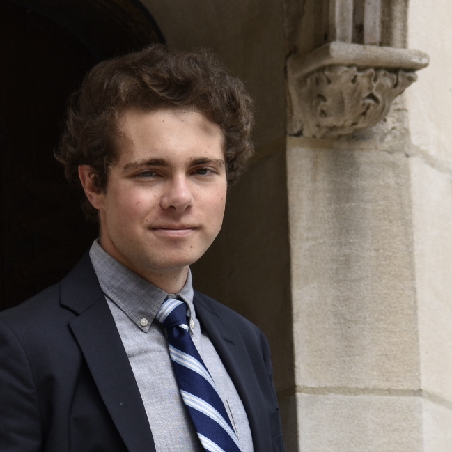 Profile Picture of Adrián Moreno (@zetxek), working side by side with a colleague: sitting on a desk, while looking at a screen